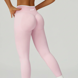 Pink leggings worn by a person on a gray background